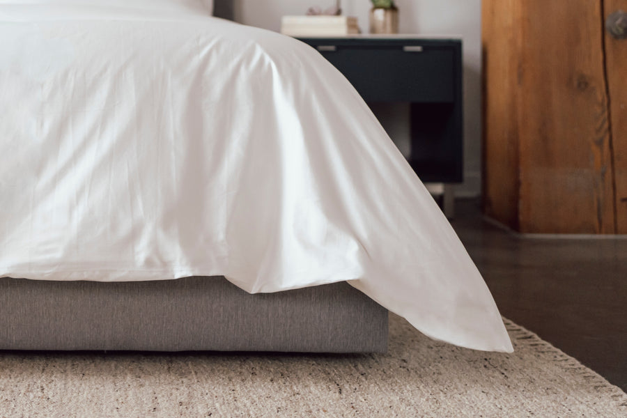 A close look at the Essential panels' smooth, edge-wrapped finish on a made bed