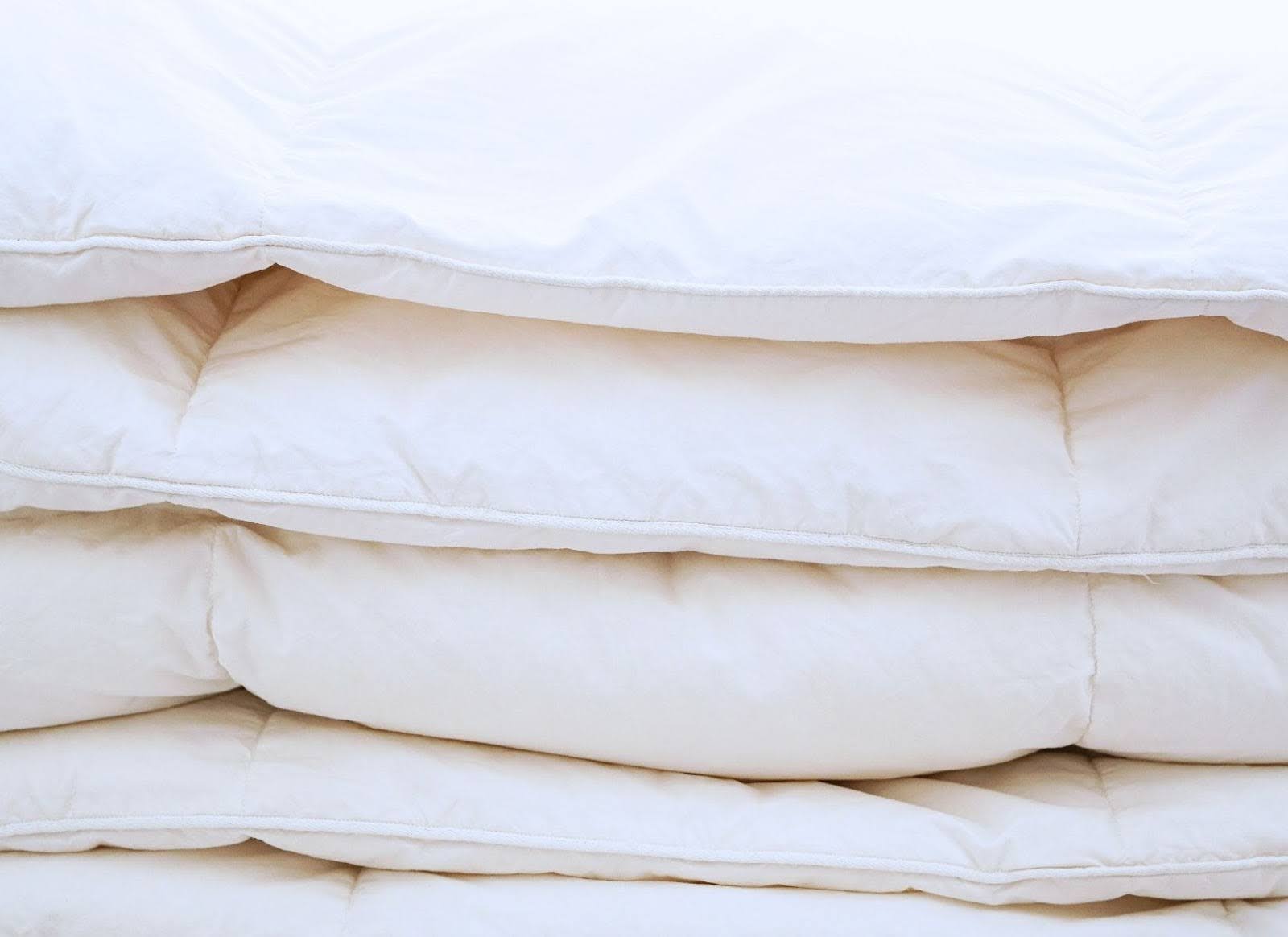 Stacked white duvet inserts showing the loft of synthetic down alternative fill
