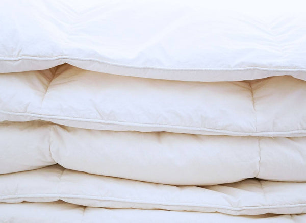 Stacked white duvet inserts showing the loft of synthetic down alternative fill