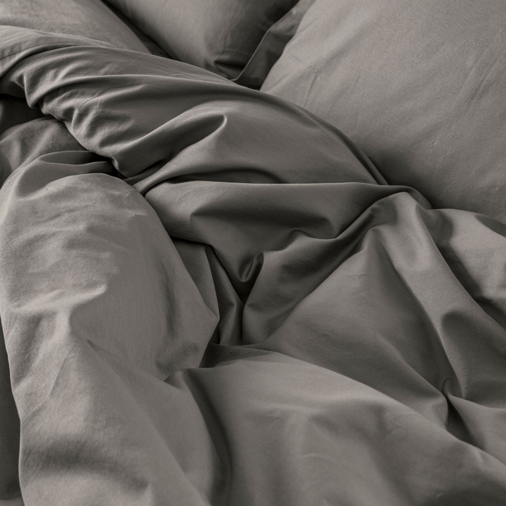 Close-up of Down for Good organic cotton duvet cover panels showing soft, breathable fabric texture