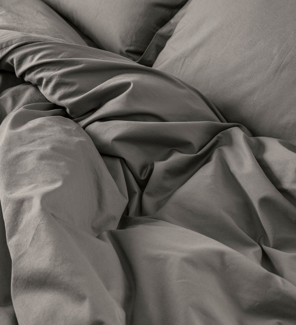 Close-up of Down for Good organic cotton duvet cover panels showing soft, breathable fabric texture