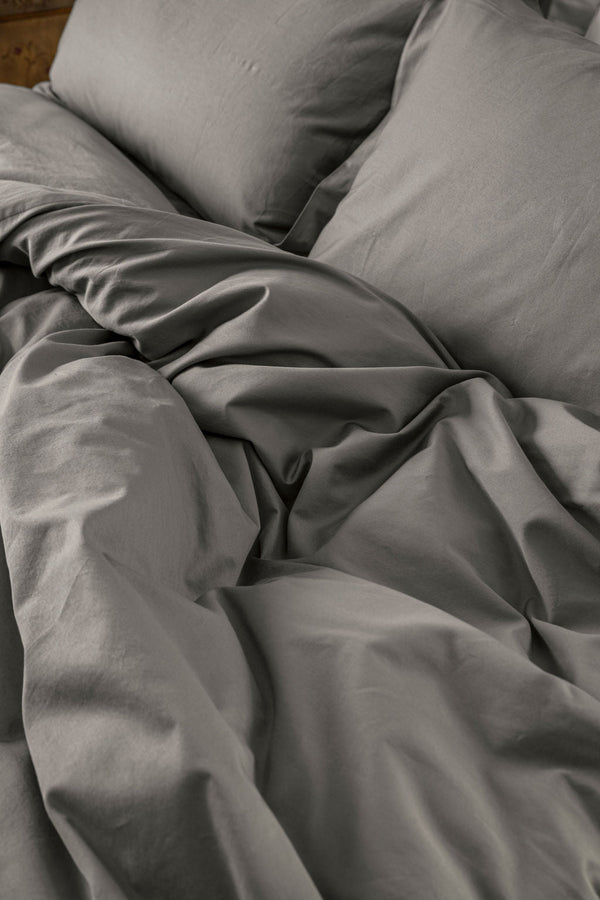 Close-up of Down for Good organic cotton duvet cover panels showing soft, breathable fabric texture