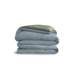 Down for Good Essential duvet cover panels, folded and stacked, in Blue Haze and Willow organic cotton.