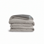 Down for Good Essential duvet cover panels, folded and stacked, in Fog and Riverbed organic cotton.
