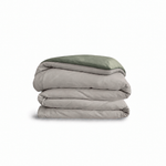 Down for Good Essential duvet cover panels, folded and stacked, in Fog and Willow organic cotton.