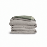 Down for Good Essential duvet cover panels, folded and stacked, in Fog and Willow organic cotton.