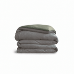 Down for Good Essential duvet cover panels, folded and stacked, in Riverbed and Willow organic cotton.