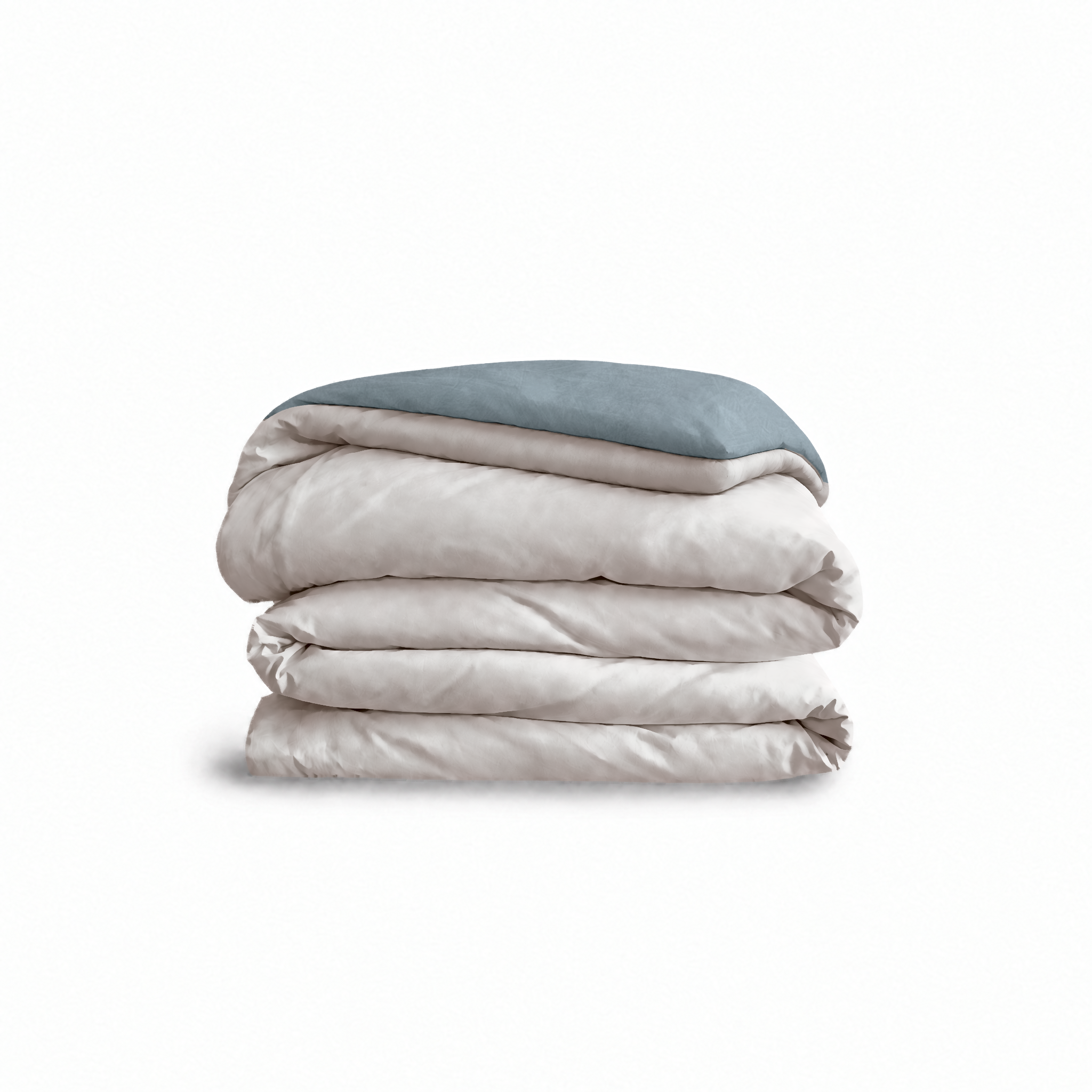 Down for Good Essential duvet cover panels, folded and stacked, in Shell and Blue Haze organic cotton.