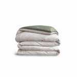 Down for Good Essential duvet cover panels, folded and stacked, in Shell and Willow organic cotton.