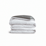 Down for Good Essential duvet cover panels, folded and stacked, in White and Riverbed organic cotton.