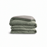 Down for Good Essential duvet cover panels, folded and stacked, in Willow and Fog organic cotton.