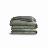 Down for Good Essential duvet cover panels, folded and stacked, in Willow and Riverbed organic cotton.