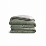 Down for Good Essential duvet cover panels, folded and stacked, in Willow and Shell organic cotton.