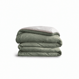 Down for Good Essential duvet cover panels, folded and stacked, in Willow and Shell organic cotton.