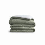 Down for Good Essential duvet cover panels, folded and stacked, in Willow and White organic cotton.