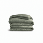 Down for Good Essential duvet cover panels, folded and stacked, in Willow organic cotton.
