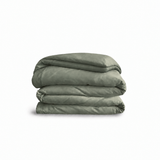 Down for Good Essential duvet cover panels, folded and stacked, in Willow organic cotton.