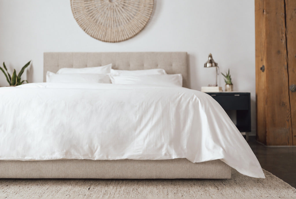Essential zip-on duvet cover panels on a made bed, with a clean edge-wrapped finish